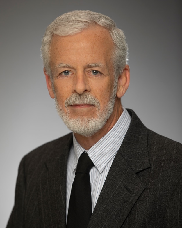 Studio portrait headshot of John O'Brien, CCIM, real estate broker, at Bradley Company offices in South Bend Indiana
