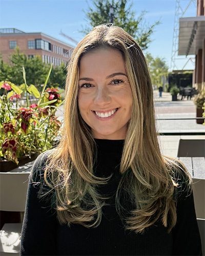 Cori Church, Brokerage Support Coordinator at Bradley Company Indianapolis Commercial Real Estate & Property Management office, outdoor photo in white shirt.