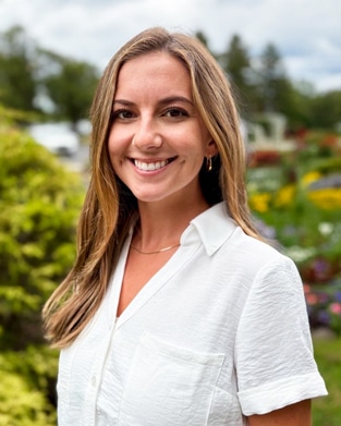 Cori Church, Brokerage Support Coordinator at Bradley Company Indianapolis Commercial Real Estate & Property Management office, outdoor photo in white shirt.